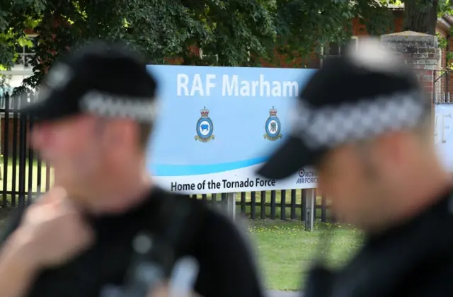 Blurred image of security forces outside RAF Marham at the time of the attempted abduction