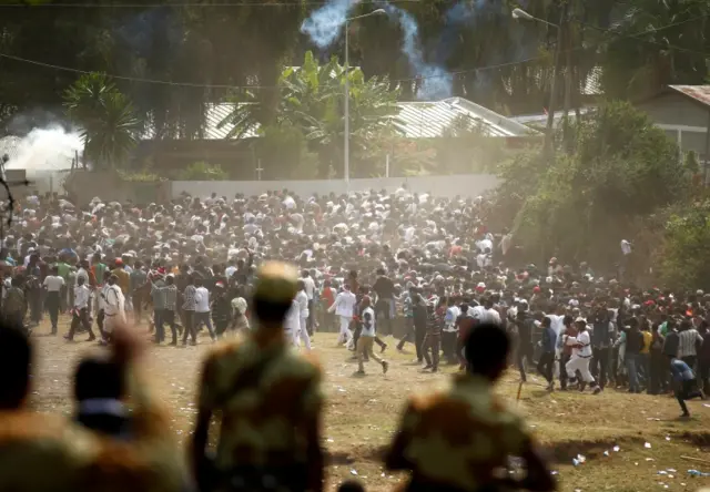 Soldiers look on at protesters