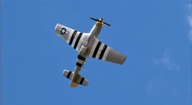 Mustang in flight, against blue skies at Old Buckenham