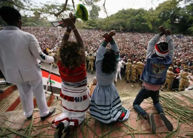 Protesters crossing their arms above their head