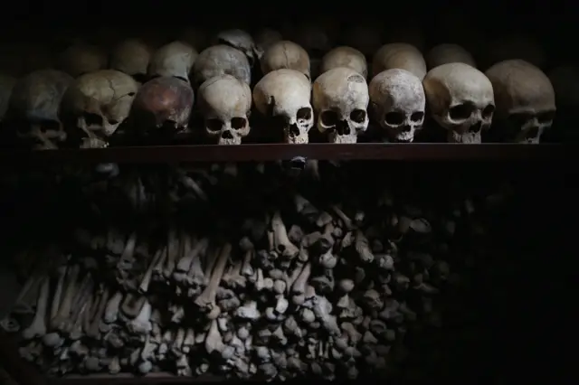 Metal racks hold the bones of thousands of genocide victims inside one of the crypts at the Nyamata Catholic Church memorial, Rwanda