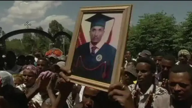 People hold picture of student up