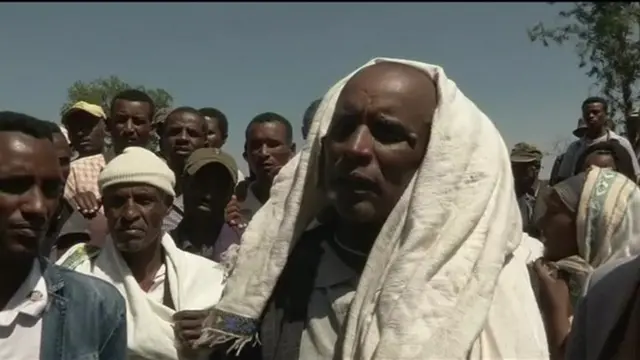 Man speaking to journalists