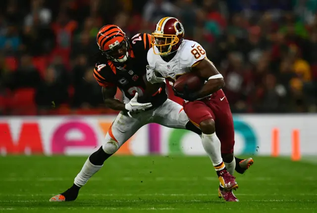 Pierre Garconof the Washington Redskins holds off Adam Jones