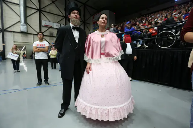 Republican presidential nominee Donald Trump supporters dressed as Abraham Lincoln and Mary Todd watch at campaign rally in Grand Rapids, Michigan.