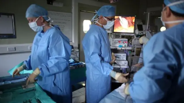 Surgeons in operating theatre