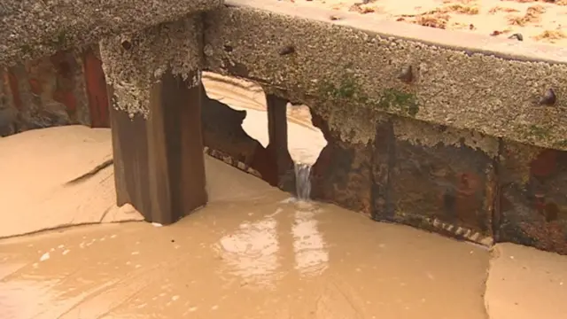 A close up view of crumbling sea defences on Bacton beach