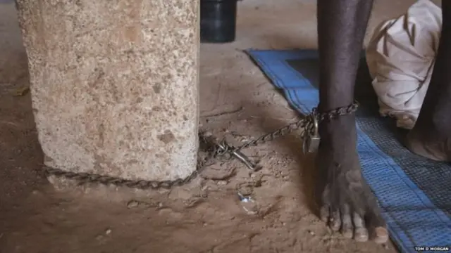 Patient with mental illness is chained to a pillar