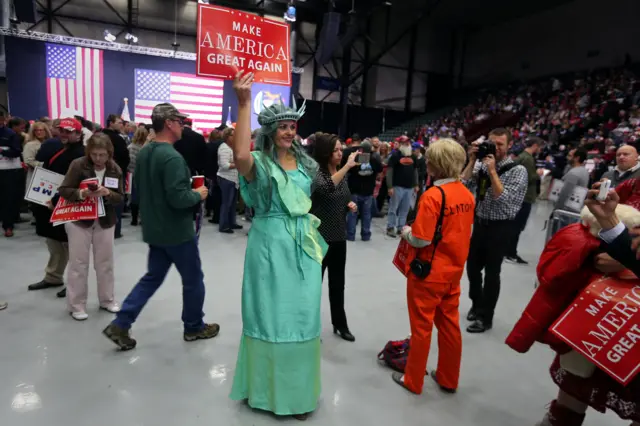 A supporter of Republican presidential nominee Donald Trump dressed as the Statue of Liberty appears at campaign rally in Grand Rapids, Michigan.