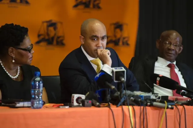 South African National Prosecuting Authority director Shaun Abrahams (C) gives a press briefing on October 31, 2016