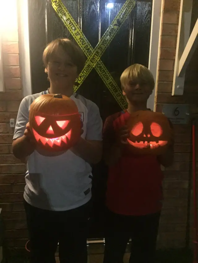 Children holding pumpkins