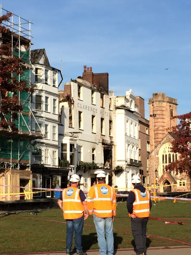 Demolition contractors look at burnt out hotel