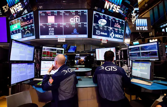 Traders work on the floor of the New York Stock Exchange