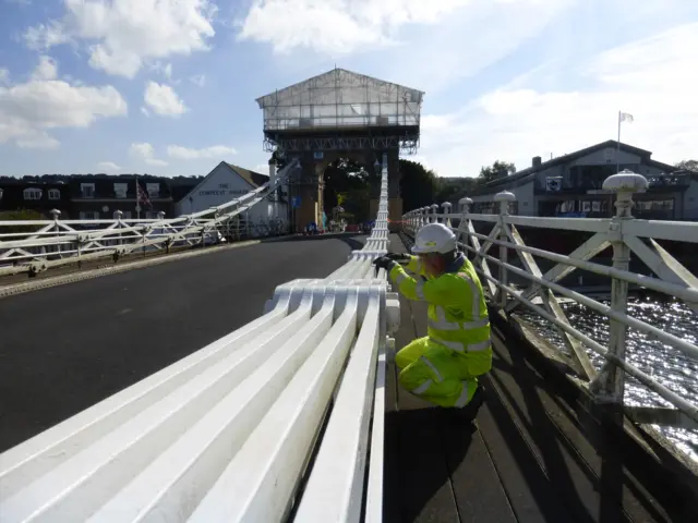 A structural engineer examining a section of Marlow Bridge's supports