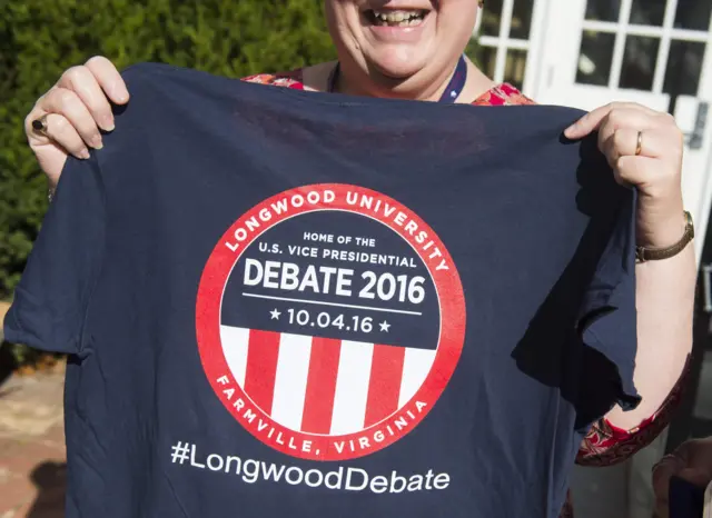 A woman holds up a t-shirt during a party ahead of the vice-presidential debate in Farmville, Virginia