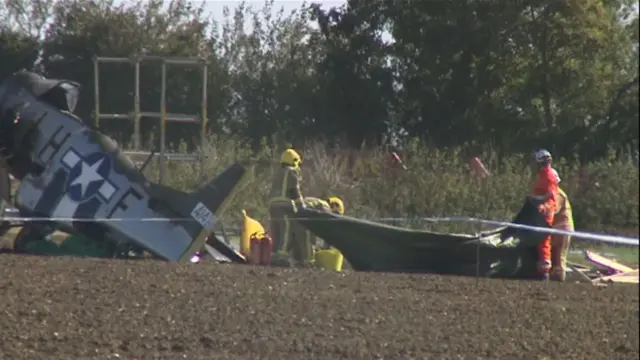 The crashed aircraft, and people in protective clothing