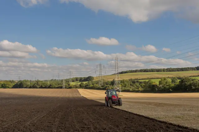 Farmer ploughing field