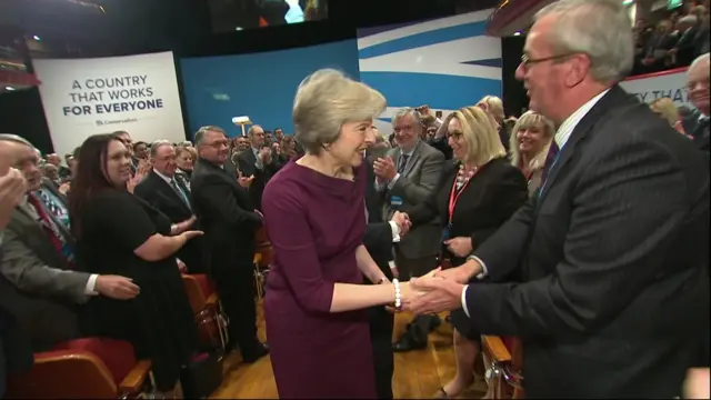 May shakes hands