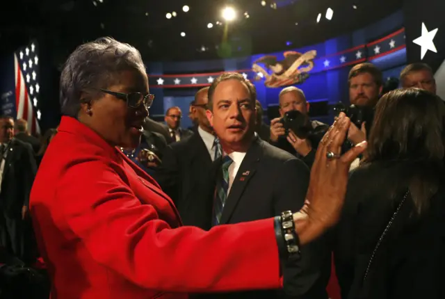 Democratic National Committee Chair Donna Brazile (L) talks with Republican National Committee Chair Reince Priebus