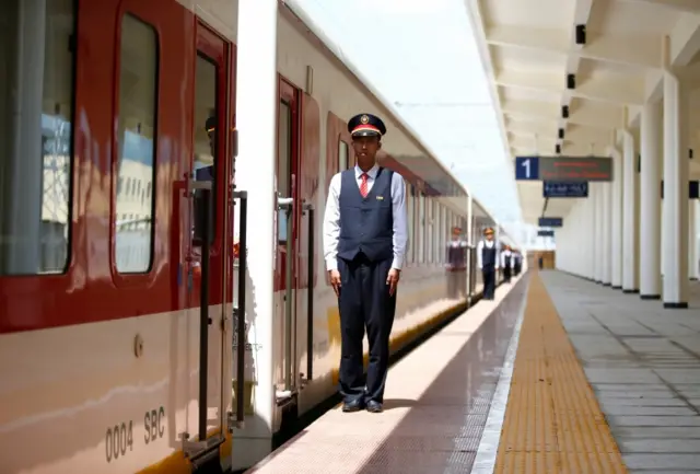 Chinese engineers stand in a line near a train at Furi train station during a media guided tour of the Ethio-Djibouti Railways route near Ethiopia"s capital Addis Ababa, September 24, 2016.