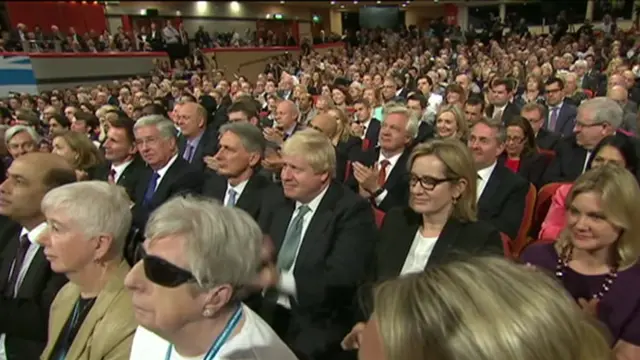 Theresa May's cabinet and the party faithful applaud the PM