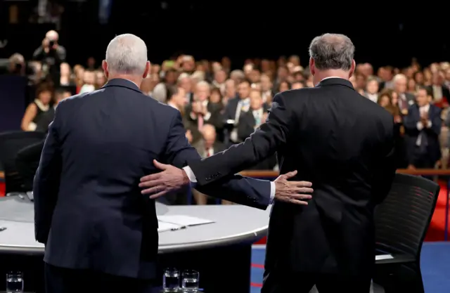 Tim Kaine and Mike Pence with an arm on each other's back - 4 October 2016