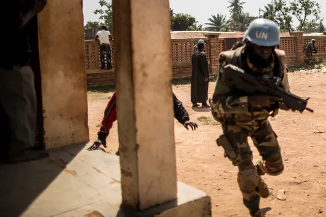 A UN peacekeeper in the CAR running for cover