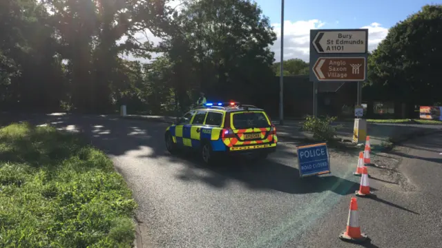 Rolling road block near Bury with police car and cones