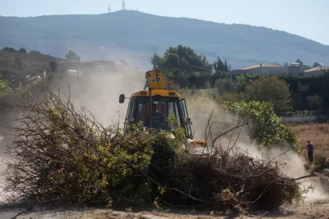 Digger removing rubble at Kos search site