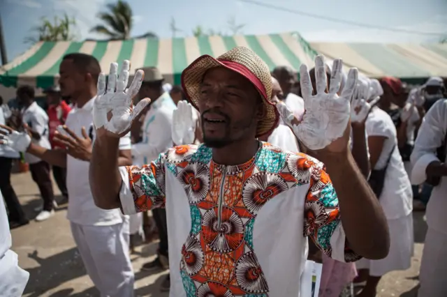 Supporters of Jean Ping with their hands painted in white as a sign of peace.