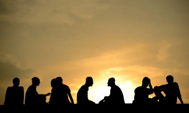 Silhouetted figures against a sky