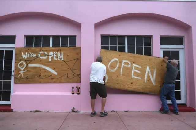 Businesses board up windows