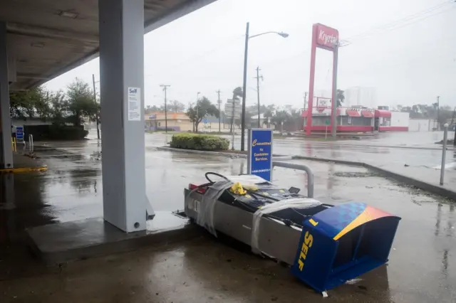 A pump station at a gas station lies on the ground in Daytona Beach