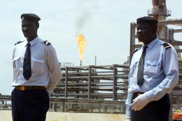 Policemen in front of flare in Chad 2003