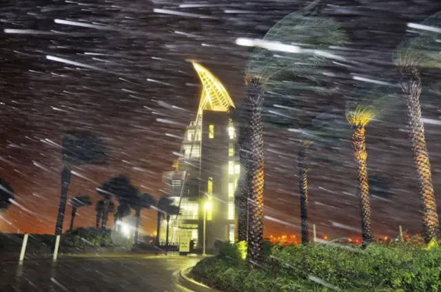 10/2016 Associated Press Trees sway from heavy rain and wind from Hurricane Matthew in front of Exploration Tower early Friday, Oct. 7, 2016 in Cape Canaveral, Fla