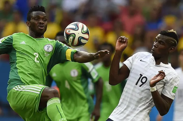 France's midfielder Paul Pogba (R) and Nigeria's defender Joseph Yobo vie for the ball during a Round of 16 football match between France and Nigeria