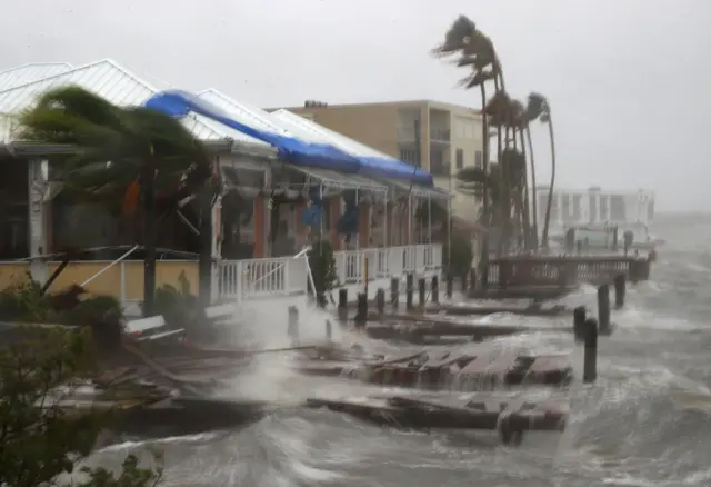 Heavy waves caused by Hurricane Matthew pounds the boat docks at the Sunset Bar and Grill on Cocoa Beach, Florida