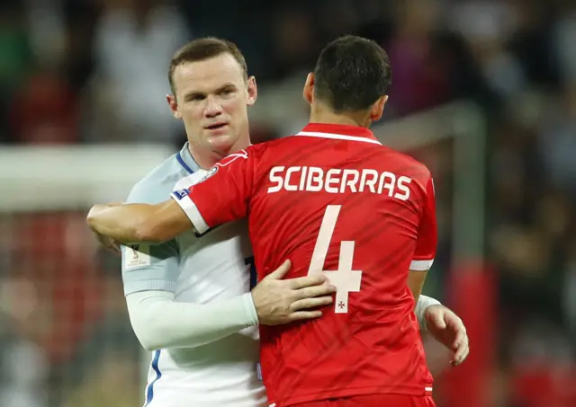 Wayne Rooney with Malta"s Gareth Sciberras following the World Cup qualifier at Wembley