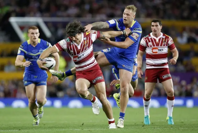 Anthony Gelling of Wigan Warriors (C) and Joe Westerman of Warrington Wolves