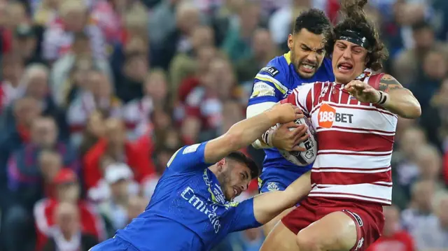 Wigan's Anthony Gelling tackled