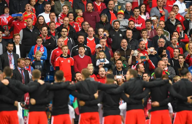 Wales fans sing the national anthem