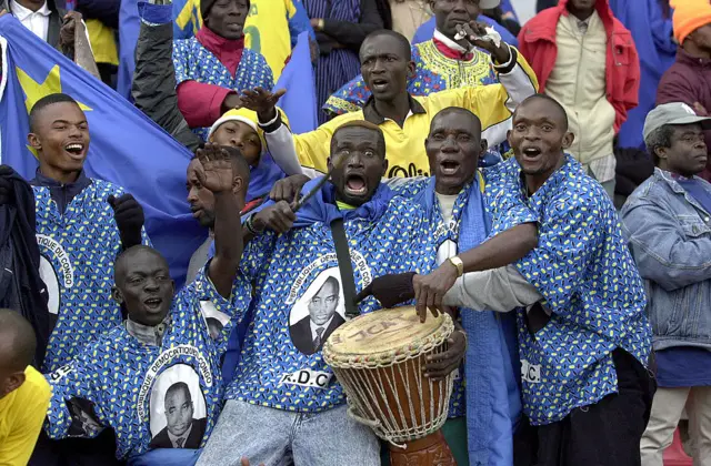 Congolese football fans celebrate inside a stadium