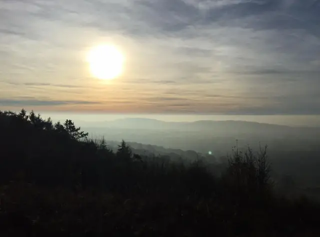 Mist can be seen settling from the Malvern Hills