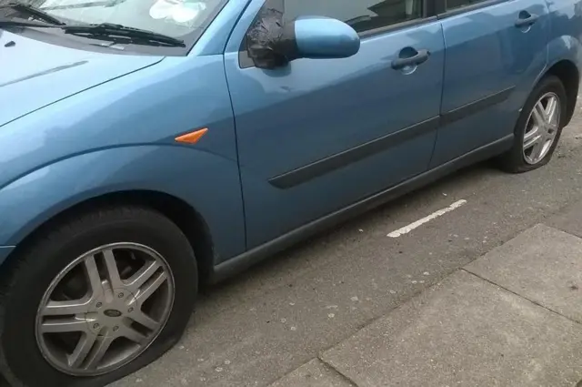 Car with tyre slashed