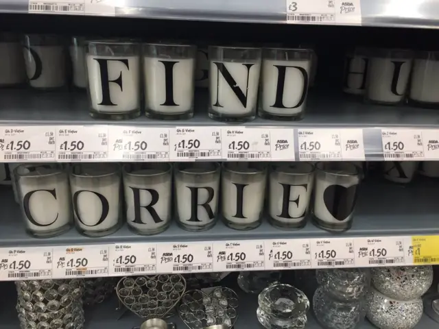 Candles spelling out 'Find Corrie'