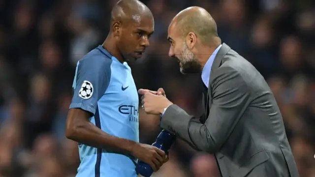 Pep Guardiola speaks to Fernandinho