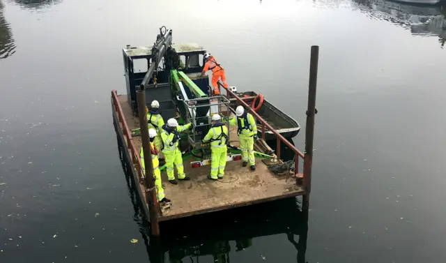 engineers on a barge approaches marlow bridge