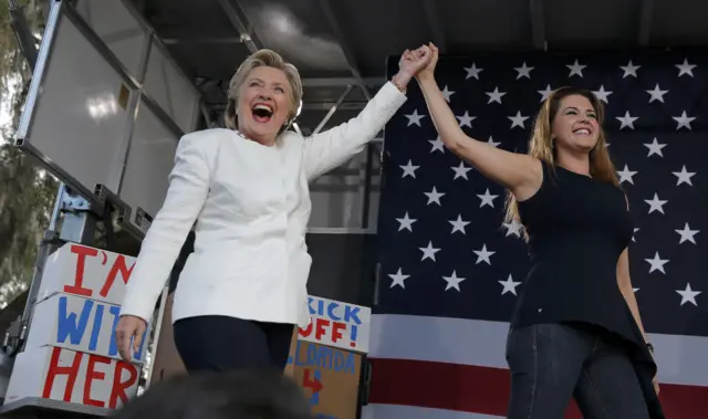 Democratic presidential nominee Hillary Clinton (L) takes the stage with Alicia Machado after being introduced at an "early voting" campaign rally at Pasco-Hernando State College in Dade City, Florida.