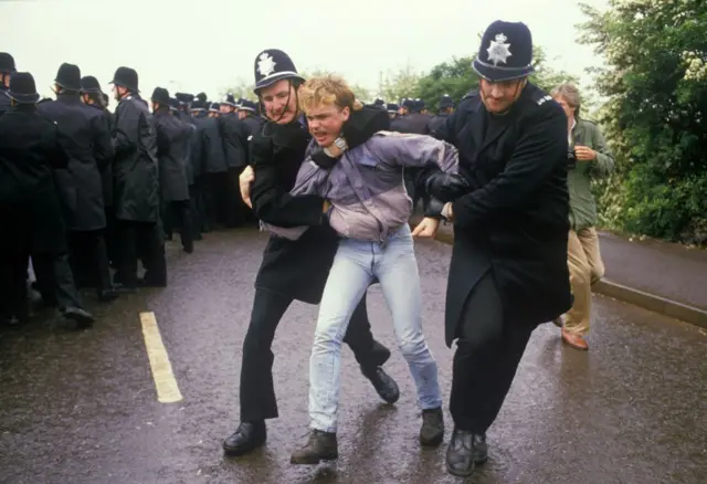 A man is held by police at Orgreave in 1984