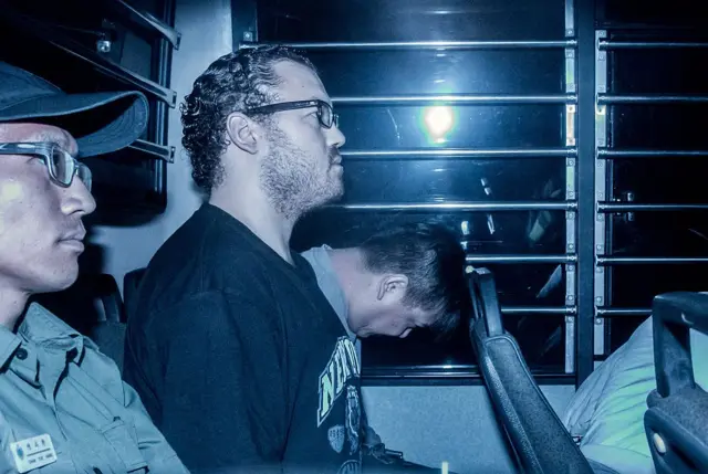 British banker Rurik Jutting sits in a prison van as he arrives at the eastern court in Hong Kong